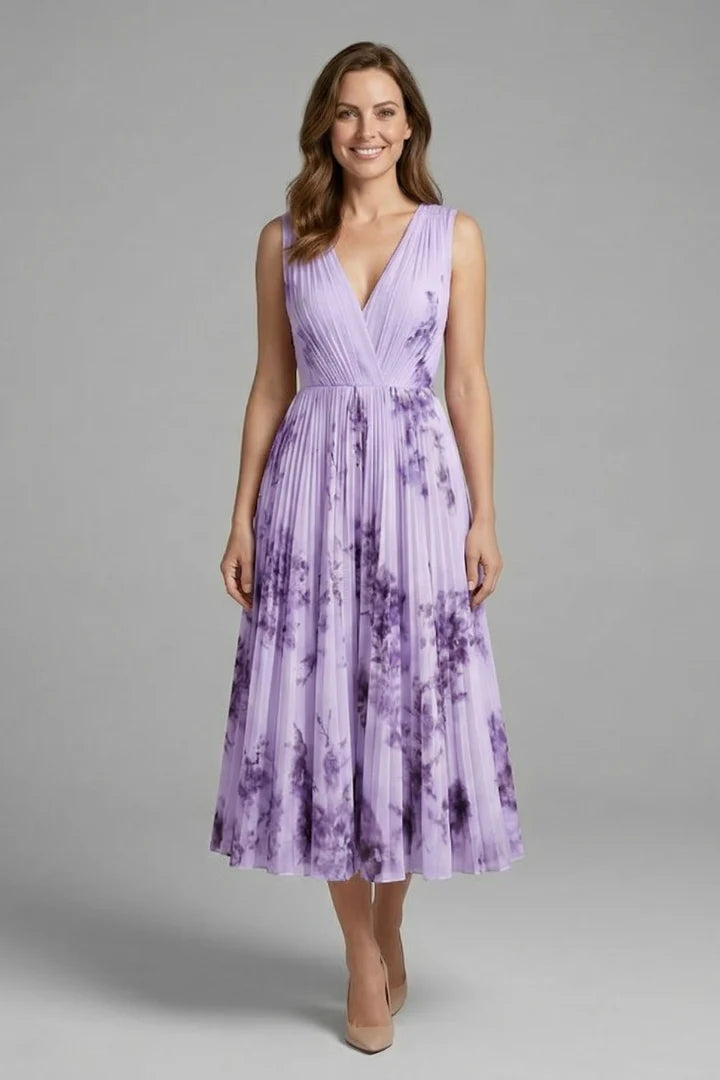 Detail of the shoulder straps and V-neckline construction on the sleeveless floral dress