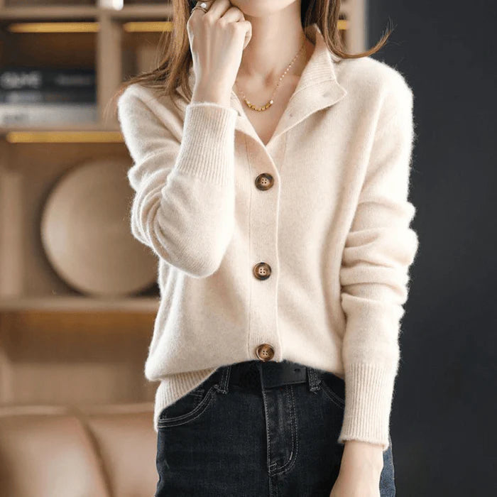 Close-up view of women's knit cardigan showing soft knit texture and button detail at neckline