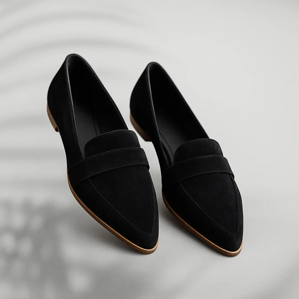 Side profile of women's slip-on loafers showing strap detail and smooth upper construction