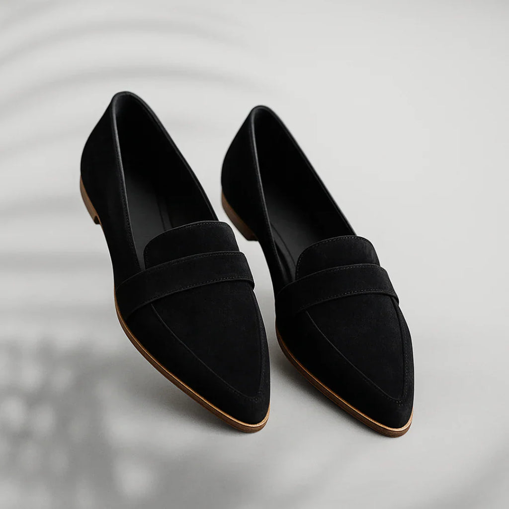 Side profile of women's slip-on loafers showing strap detail and smooth upper construction