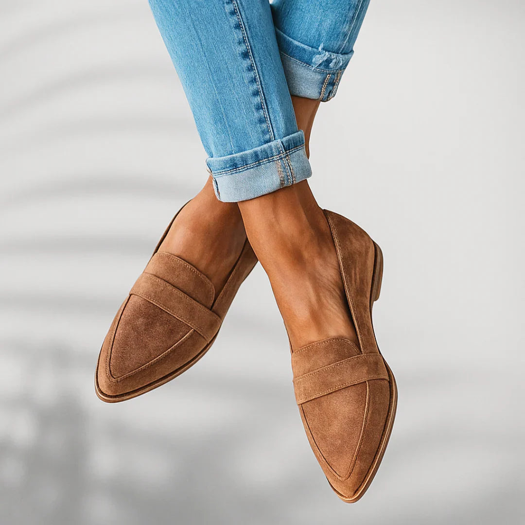 Close-up of pointed toe loafer with structured vamp strap and stacked heel detail