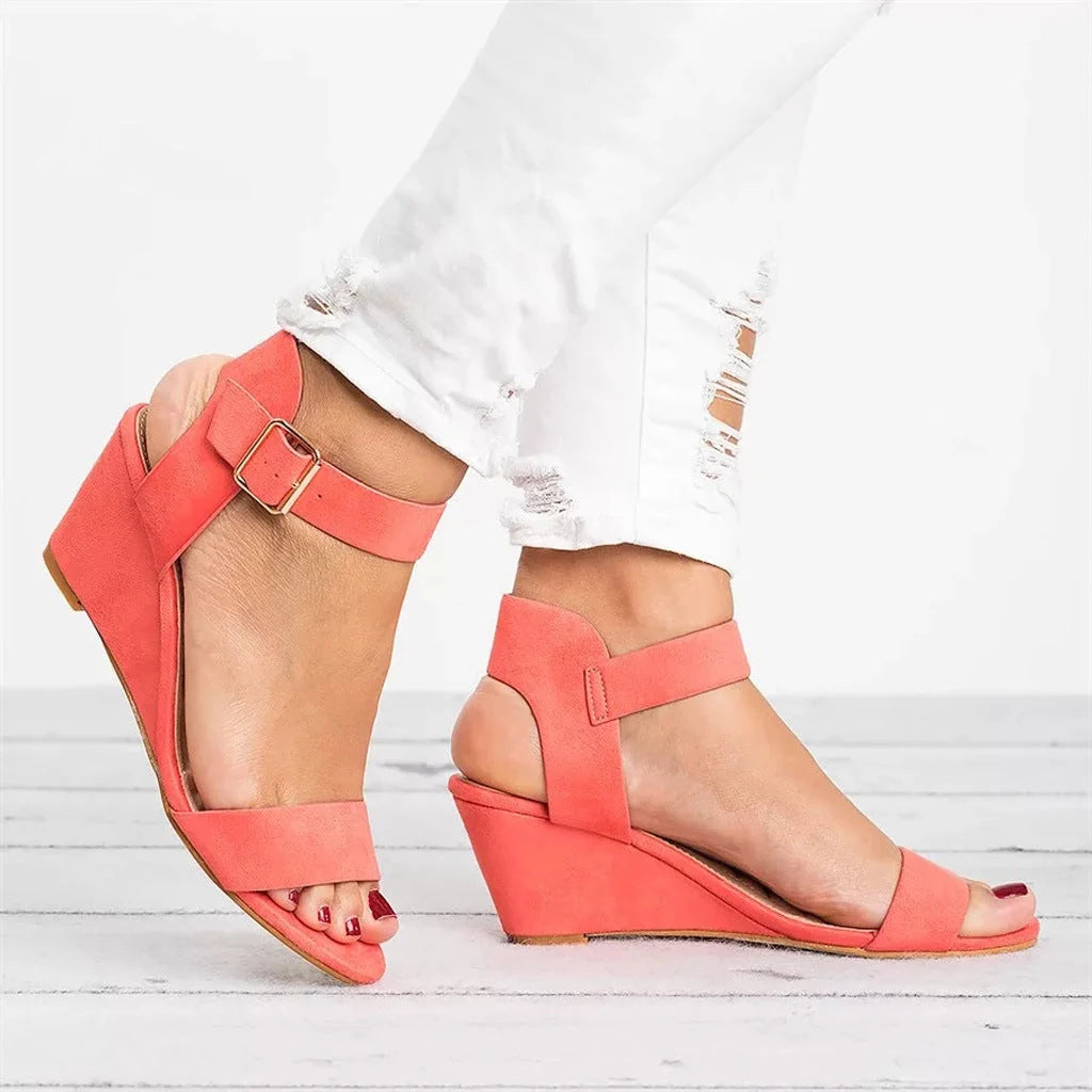 Side profile of women's wedge sandals displaying mid-height heel and slingback ankle band construction