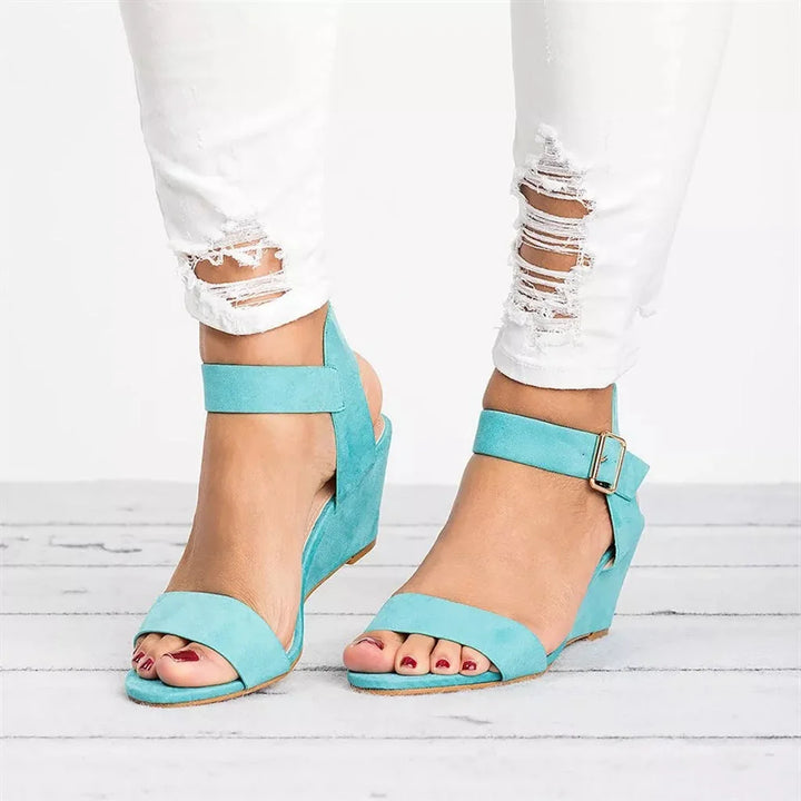 Women's open-toe wedge sandals with contoured footbed and secure ankle strap, modelled on feet