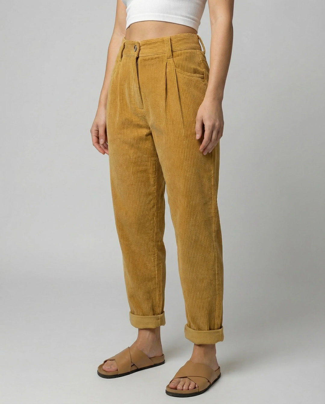 Front view of elastic waist corduroy trousers showing pleated front detail and button-tab closure