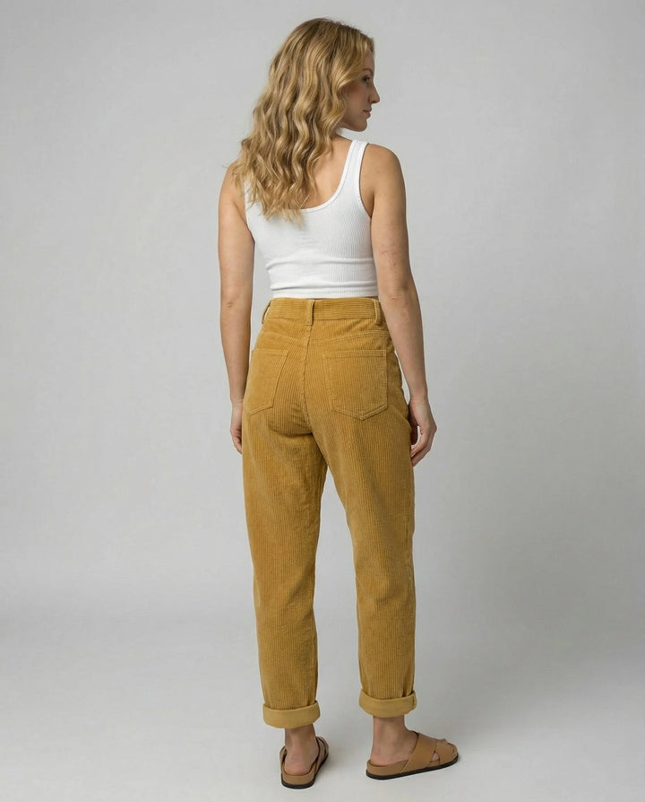 Close-up of elastic waistband and structured corduroy fabric on women's trousers