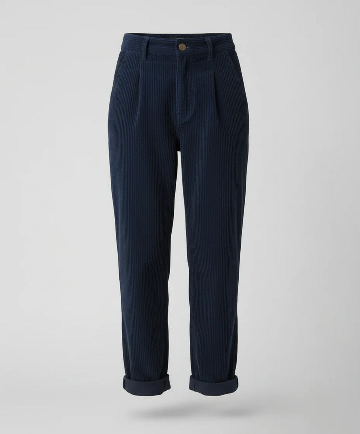 Styling view of corduroy trousers with rolled cuffs and casual sandals