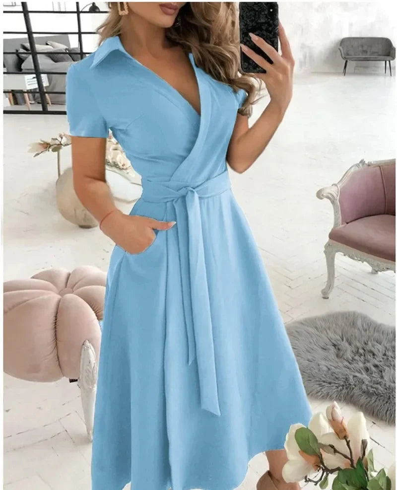 Close-up view of the tie waist detail and A-line silhouette on the midi dress