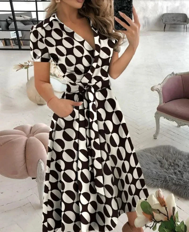 Model wearing the red midi dress styled with heeled sandals for an occasion look