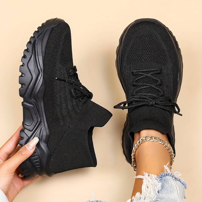 Women's white orthopedic sneakers styled with distressed denim showcasing breathable upper and chunky platform sole design
