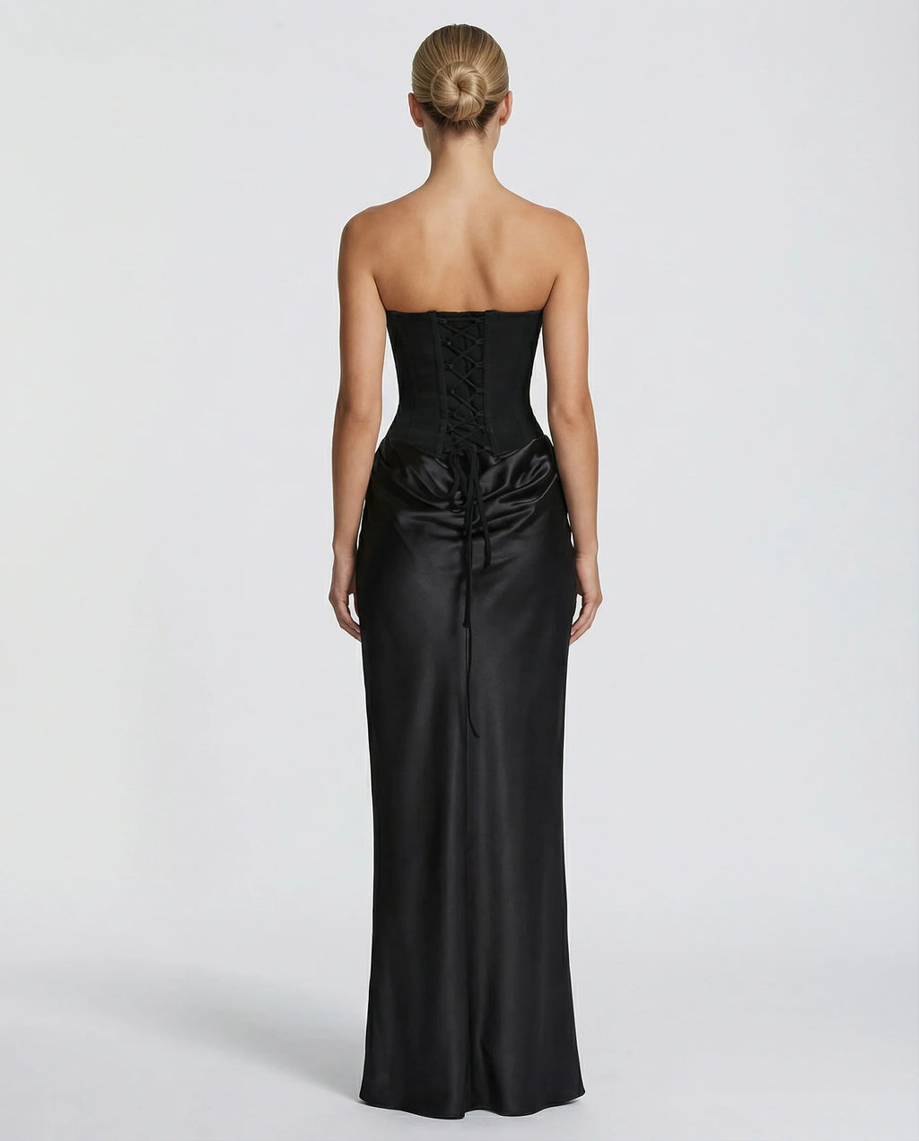 Front view of black satin maxi dress featuring sculpted corset and sheer scarf detail