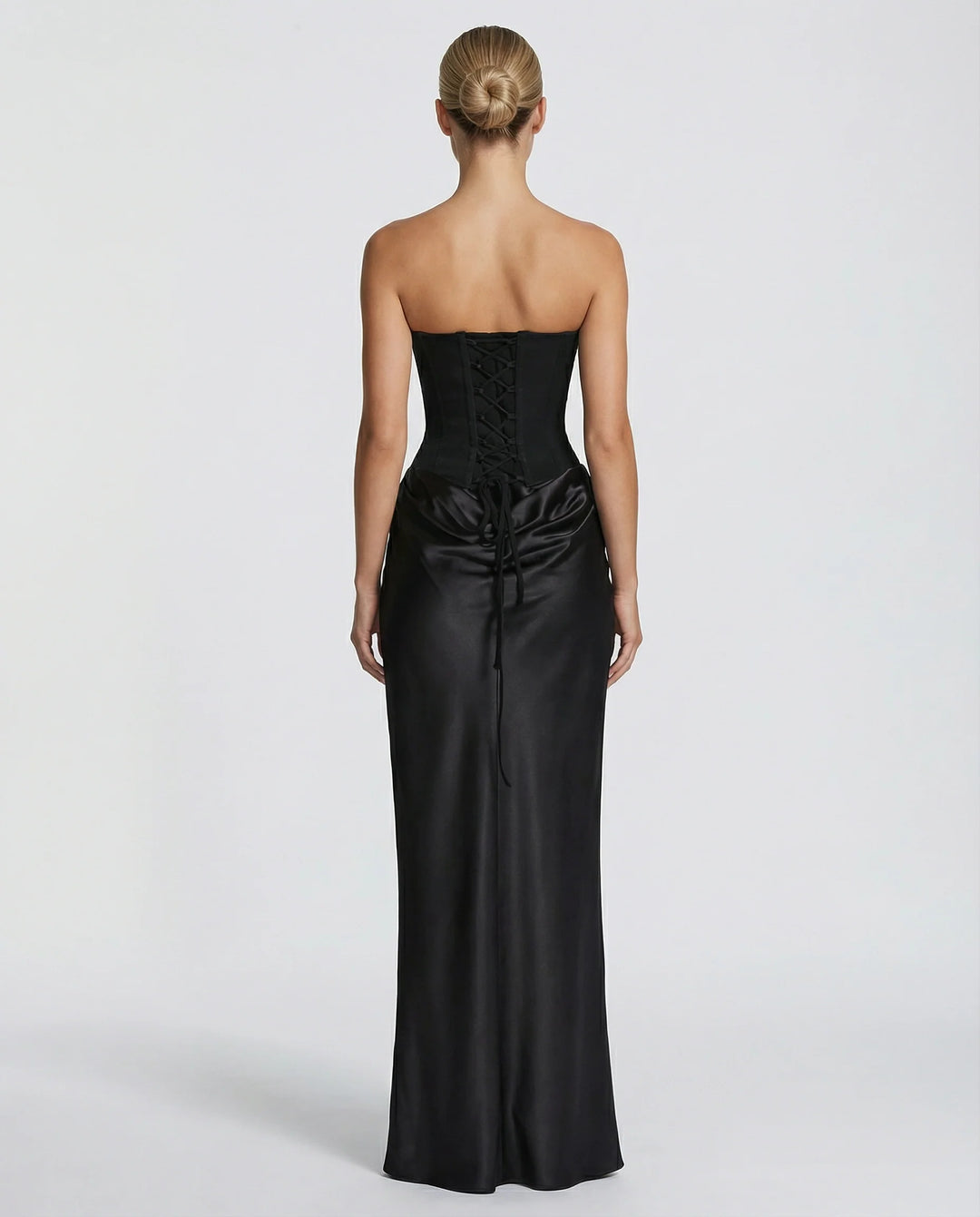 Front view of black satin maxi dress featuring sculpted corset and sheer scarf detail