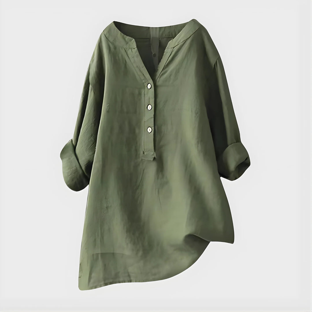 Side view of relaxed fit blouse with curved hemline and three-quarter rolled sleeves