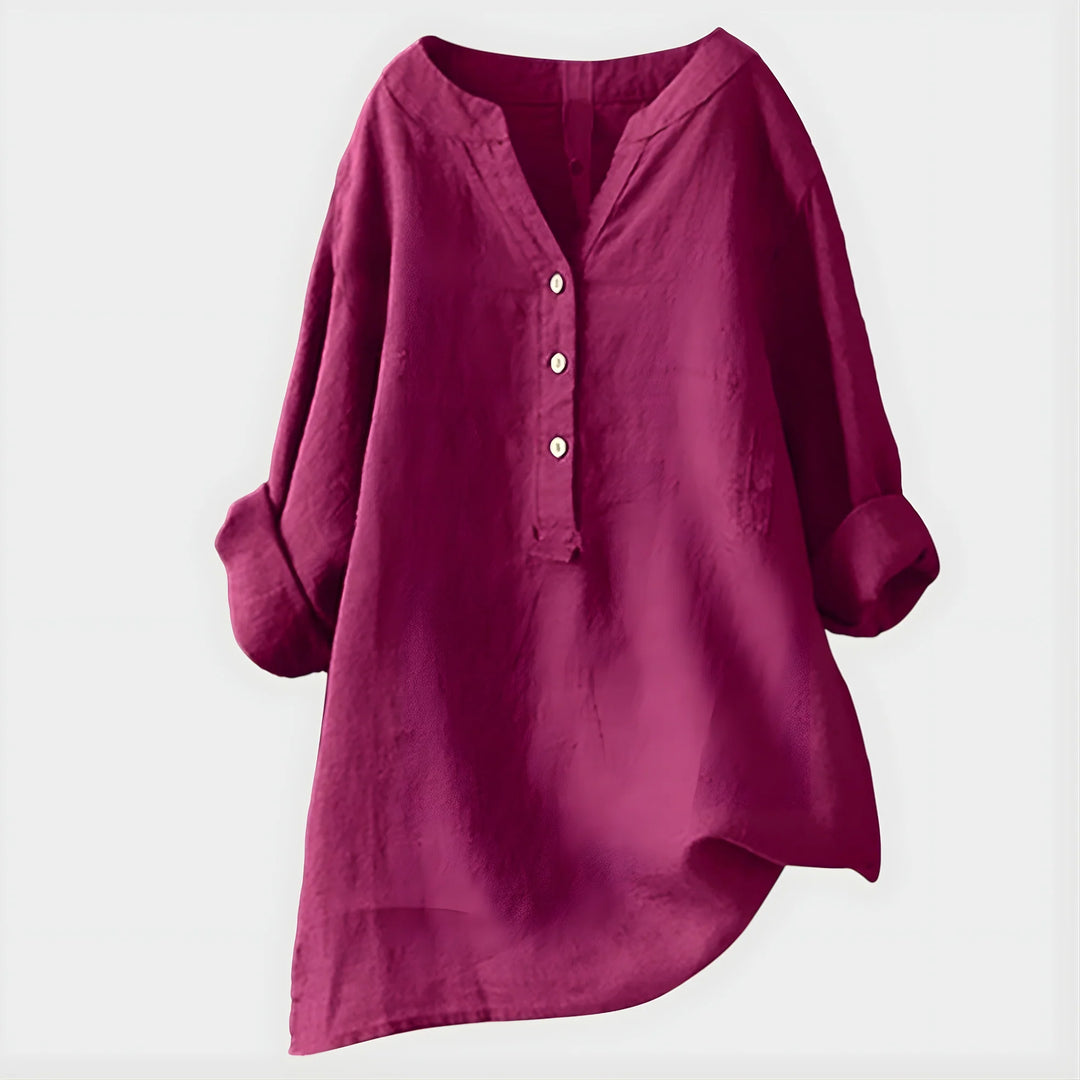 Woman wearing watermelon pink blouse with rolled sleeves and comfortable relaxed fit
