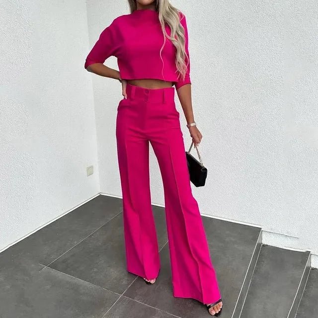 Full-length view of women's two-piece set with long sleeve cropped top and tailored trousers