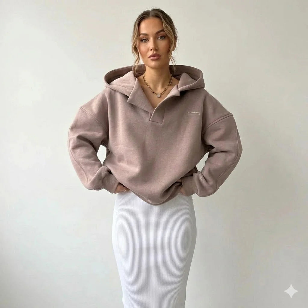 Matilda wearing a taupe Oversized Lounge Hoodie For Women with crossover hood and dropped shoulders paired with white ribbed skirt
