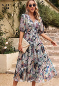 Woman wearing Women's V-Neck A-Line Midi Dress with abstract floral print and puff sleeves outdoors