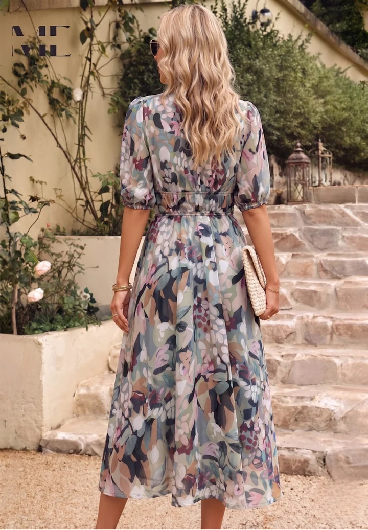 Close-up view of V-neckline and gathered puff sleeves on floral midi dress