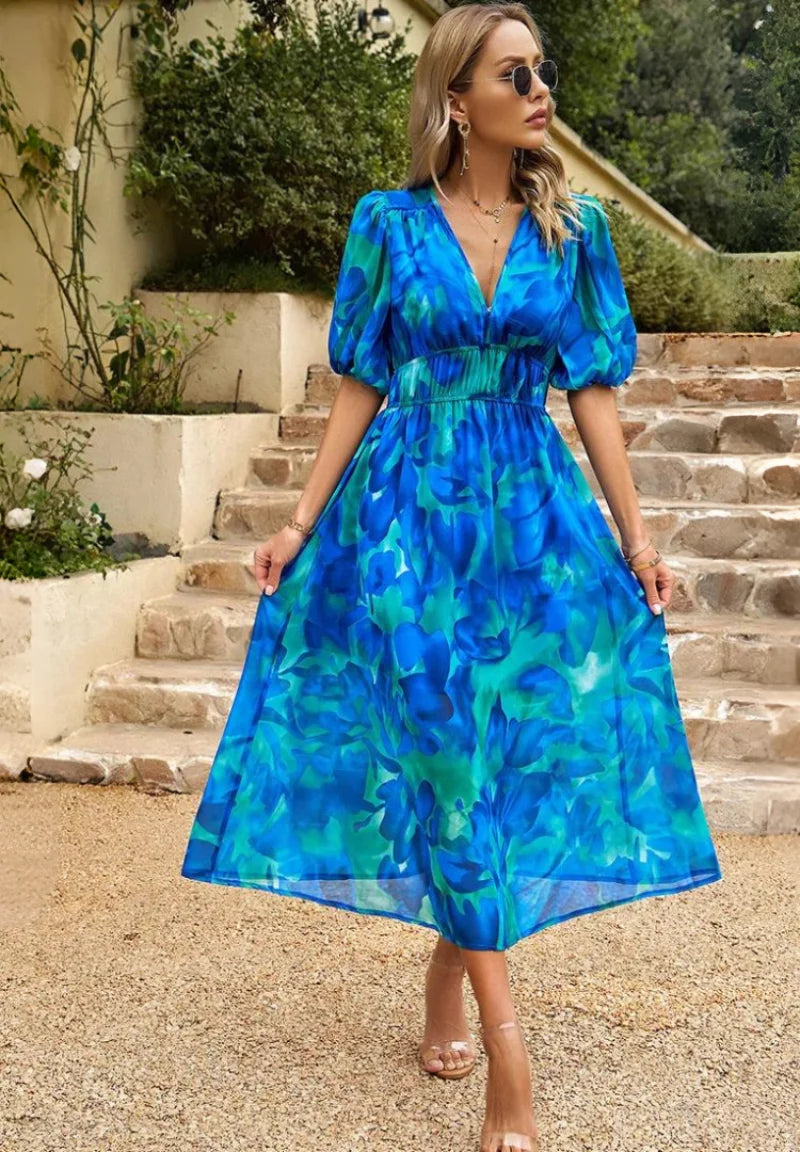 Side view showing A-line silhouette and midi length of floral print dress