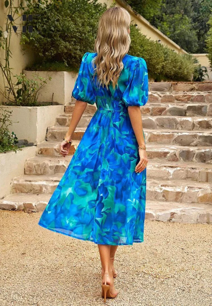 Detail of elasticated waist and flowing skirt on women's midi dress