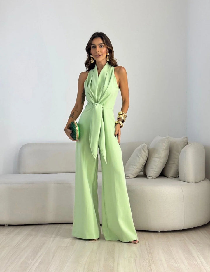 Wide-leg halterneck jumpsuit in pale green with adjustable waist tie and flowing trousers