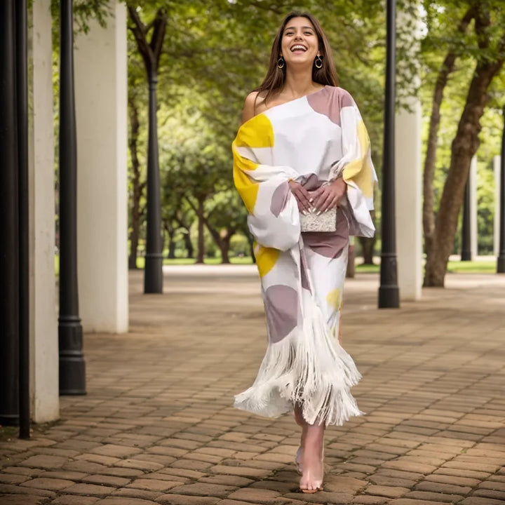 Close-up view of one shoulder wrap midi dress showing balloon sleeves and fringe detail