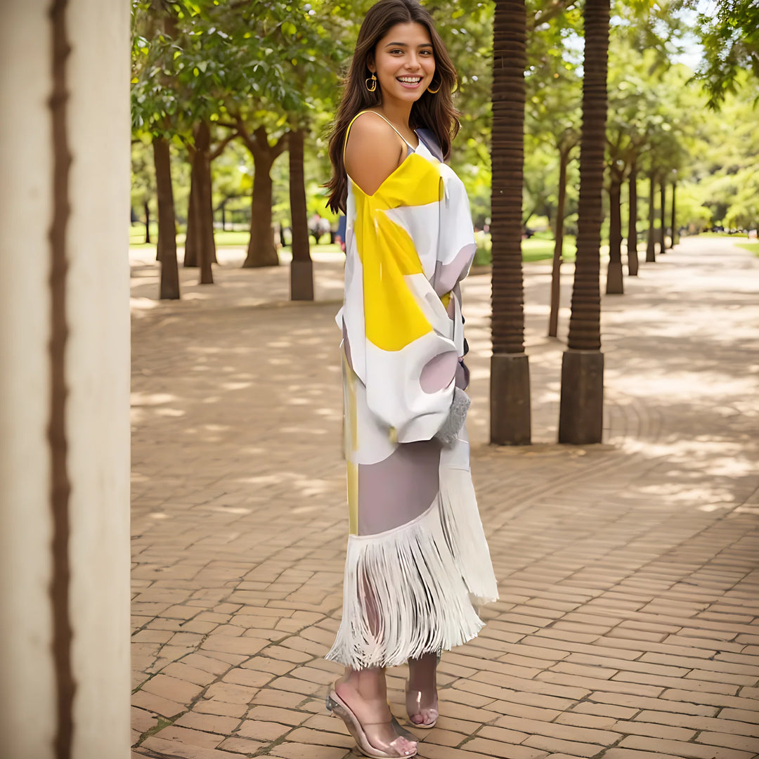 Full-length view of geometric print midi dress with fringe hem and one shoulder design