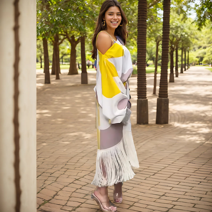 Full-length view of geometric print midi dress with fringe hem and one shoulder design