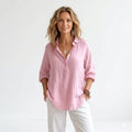 Woman wearing Blush Linen Relaxed Shirt with Effortless Elegance For Women in soft pink with V-neckline and long sleeves