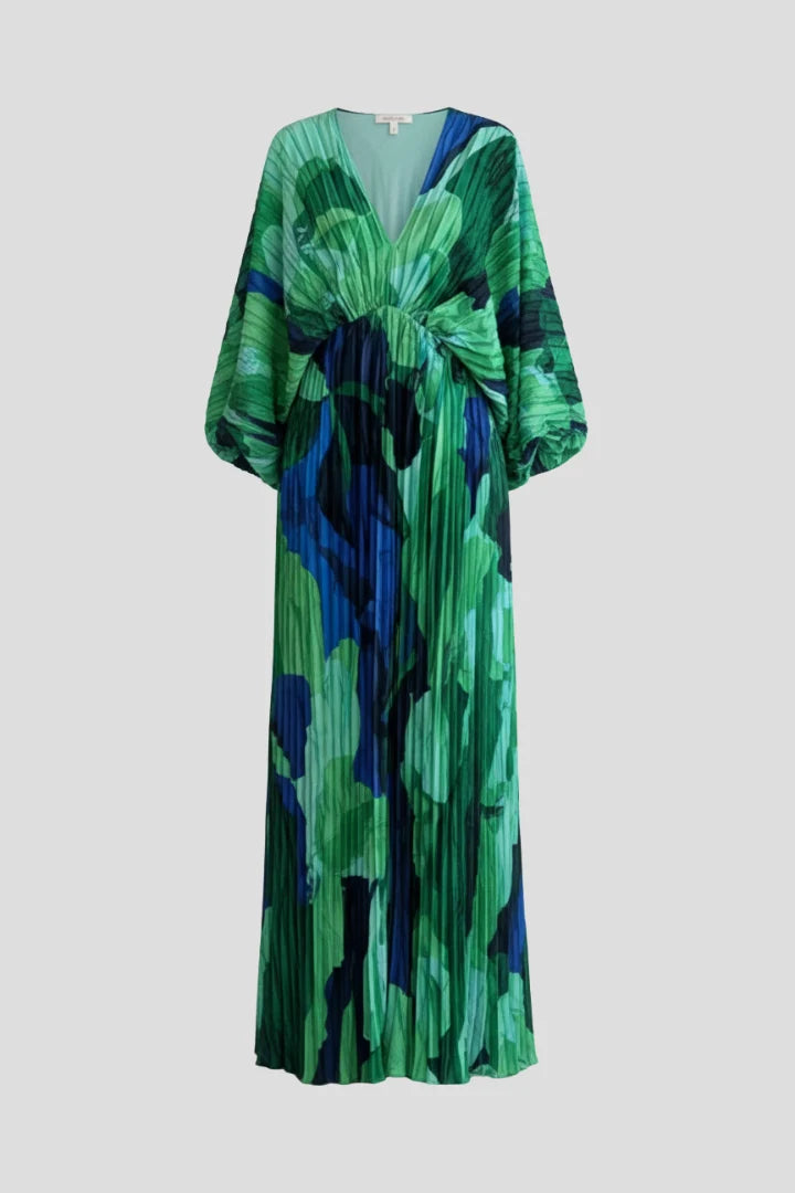 Full-length view of pleated maxi dress with deep V-neckline and loose long sleeves in vibrant print