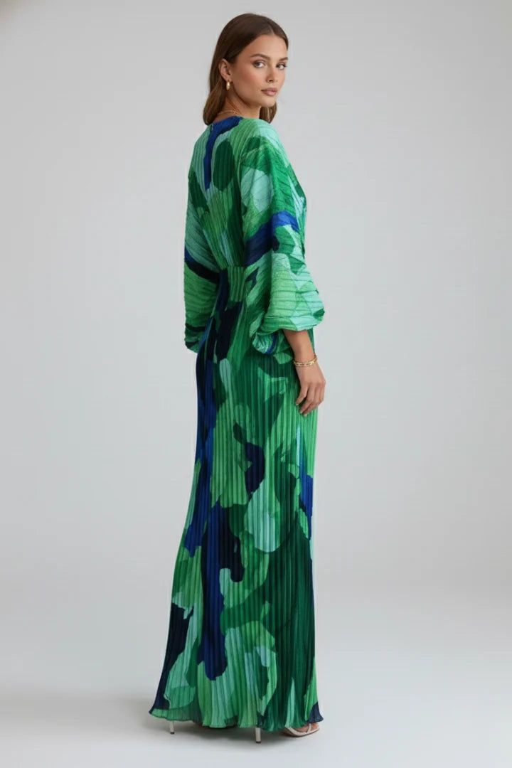 Close-up detail of gathered waist and pleated texture on women's long dress with flowing silhouette