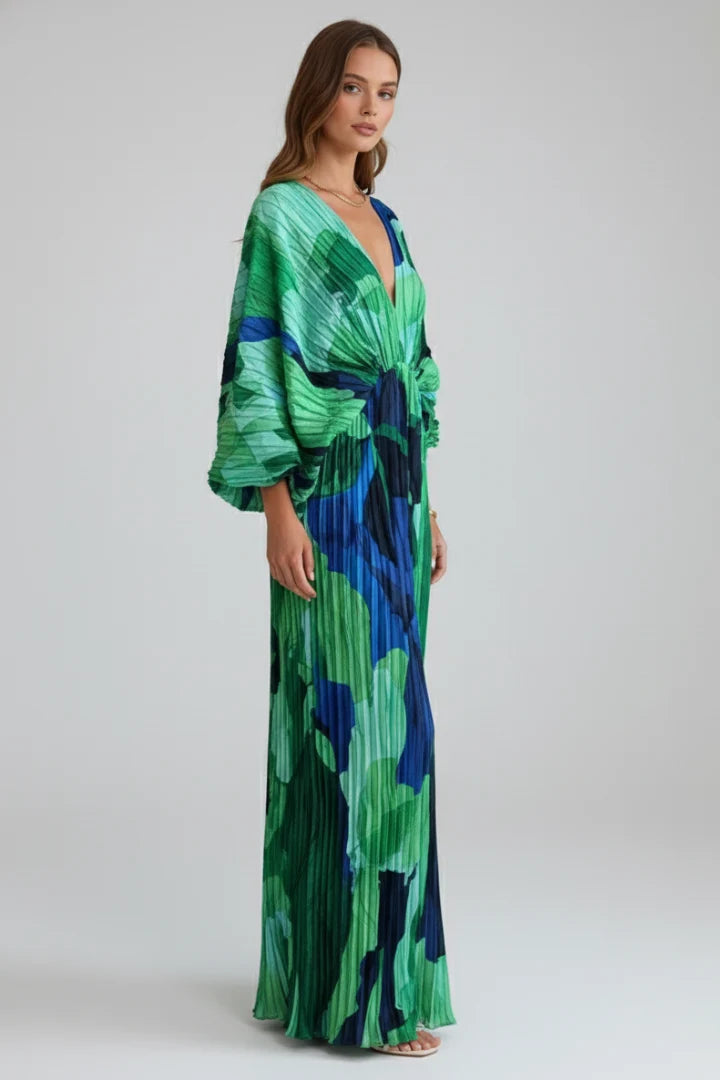 Women's pleated maxi dress with V-neckline styled with strappy heels for evening wear