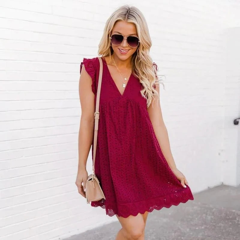 Woman styling 2-in-1 dress with built in shorts with woven bag for casual daytime look