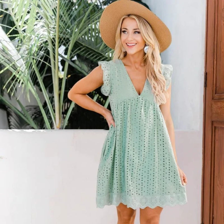 Close-up of hidden side pockets and eyelet detailing on casual dress with built-in shorts