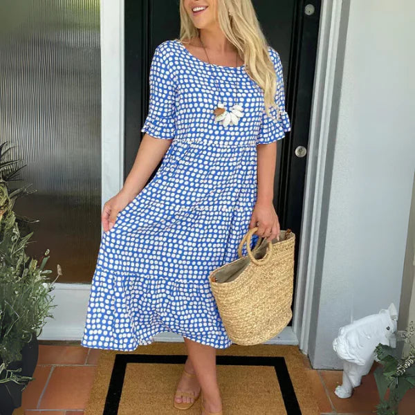 Woman styling polka dot tiered midi dress for casual daywear with natural drape