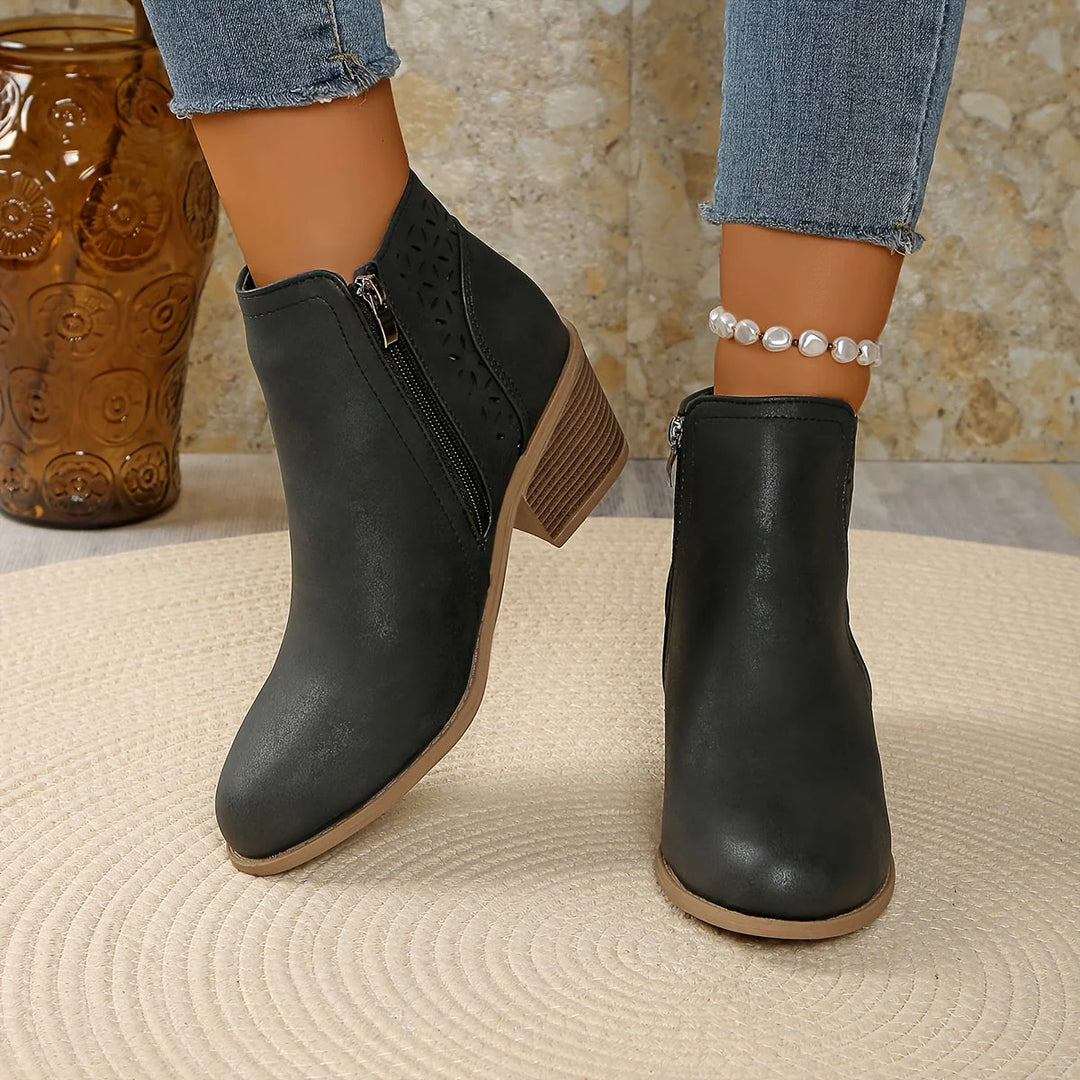 Women's ankle boots cutout detail in blue showing heel height and ankle coverage