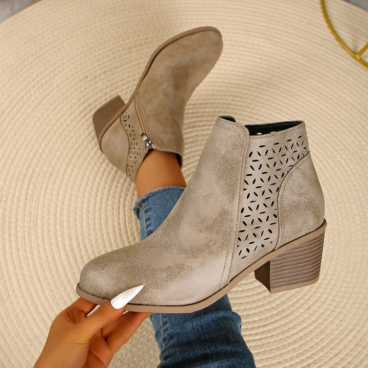 Full view of women's ankle boots featuring perforated shaft design and block heel