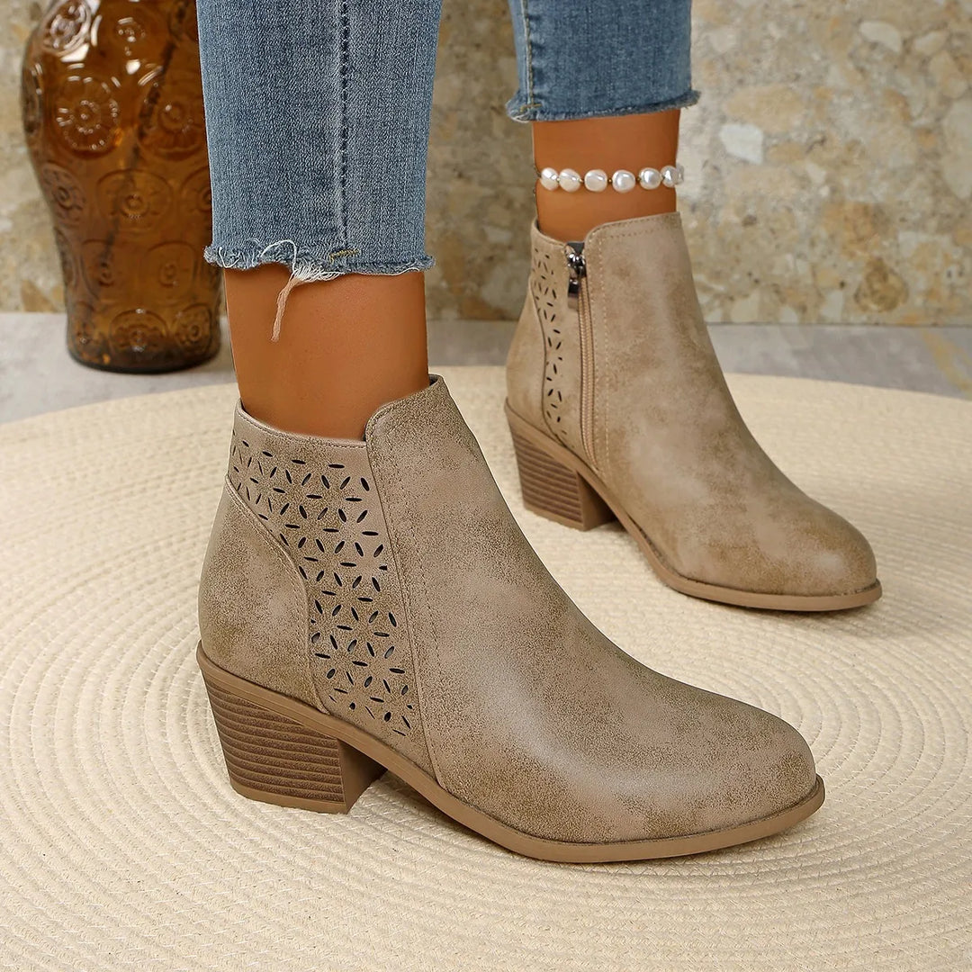 Women's ankle boots cutout detail showing breathable perforated design and zip closure