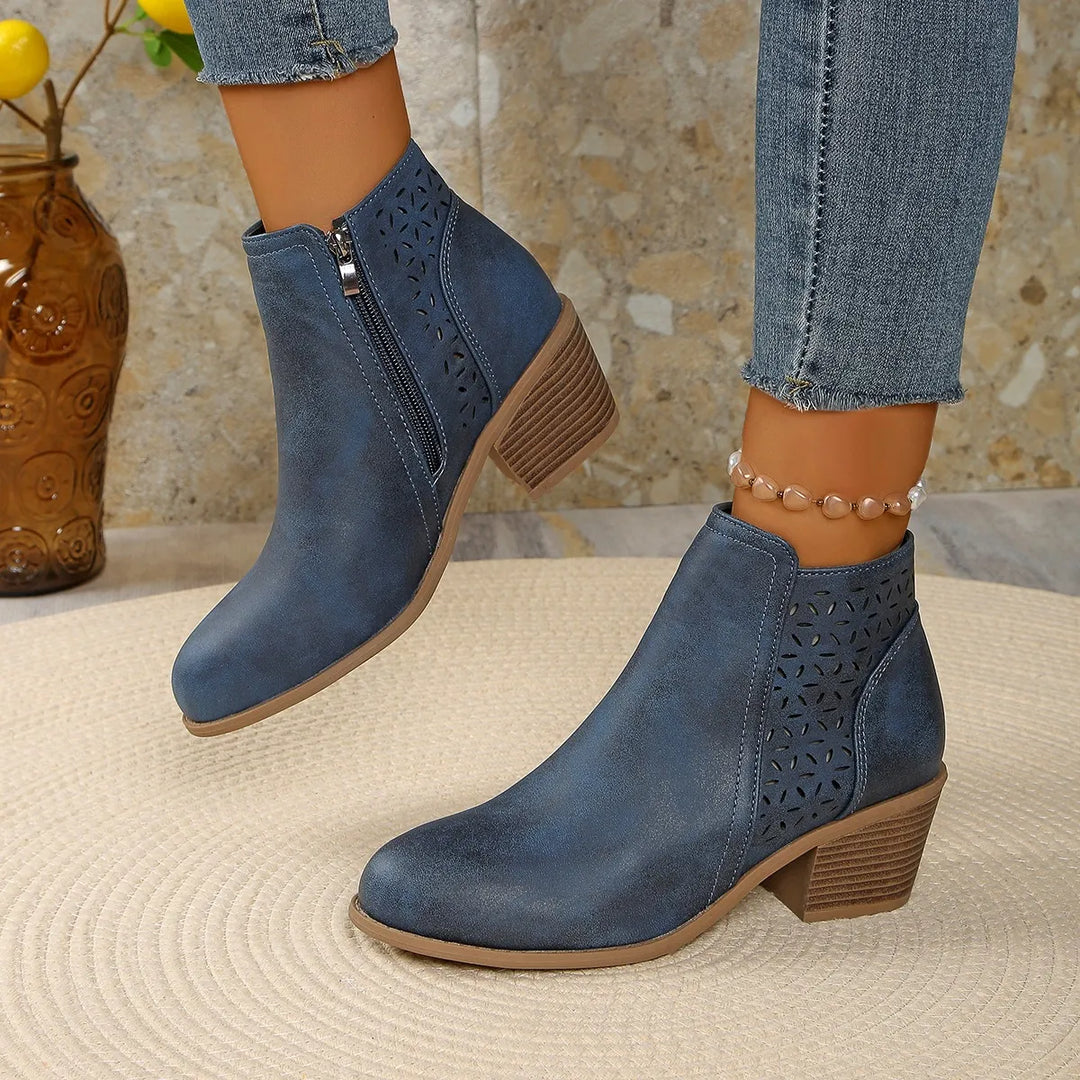 Close-up detail of geometric cutout design on women's ankle boots with stacked heel