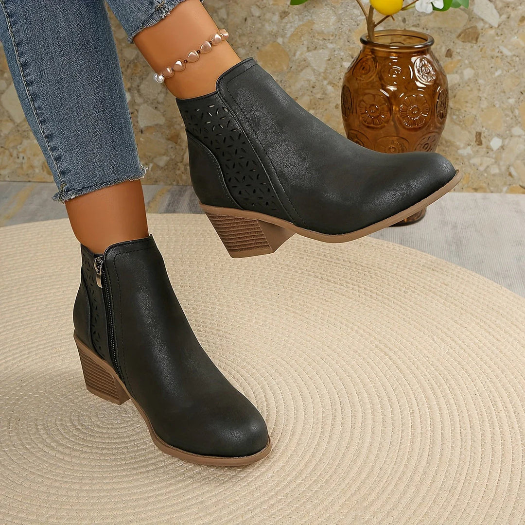 Overhead view of women's ankle boots with geometric cutout detailing and side zip