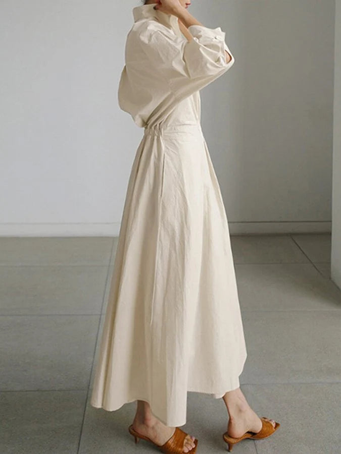 Close-up of belted waist detail on women's collared A-line midi dress