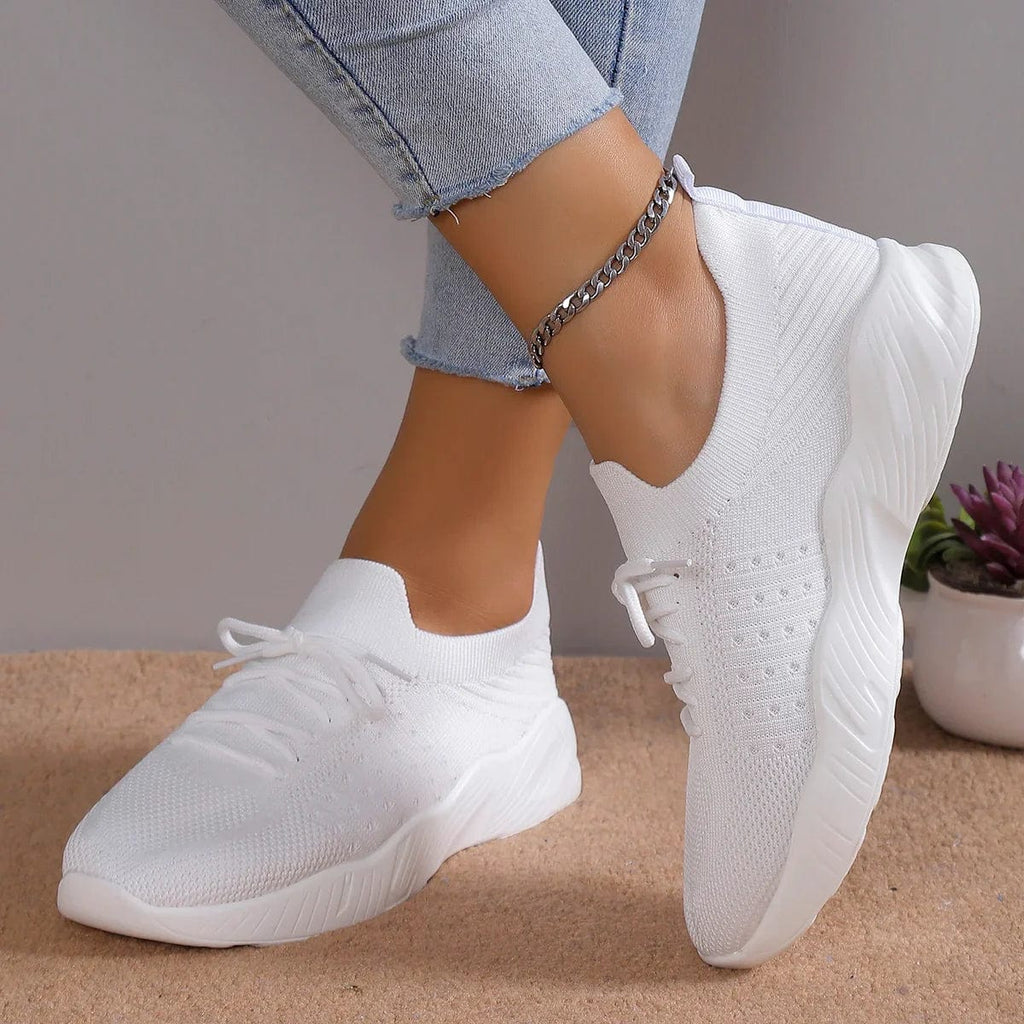 Close-up of sky blue knitted trainers showing textured mesh upper and ribbed ankle collar detail