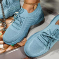 Front view of lace-up orthopedic shoes showing rounded toe box and textured knit fabric