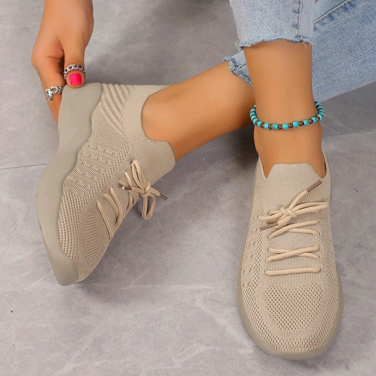 Overhead view of knitted comfort shoes displaying lace-up closure and ribbed collar construction