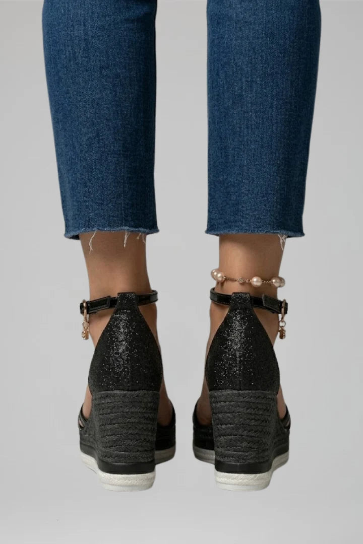 Detail of espadrille-wrapped wedge heel with contrast trim and textured upper straps