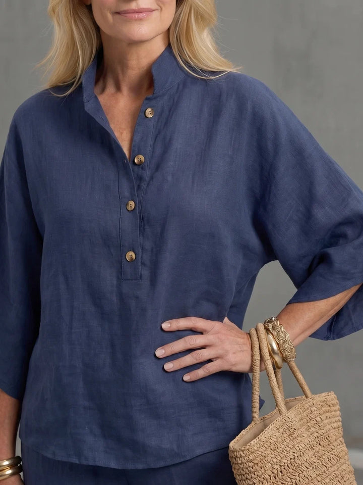 Stand collar top with three-button placket paired with straight-leg trousers in relaxed fit