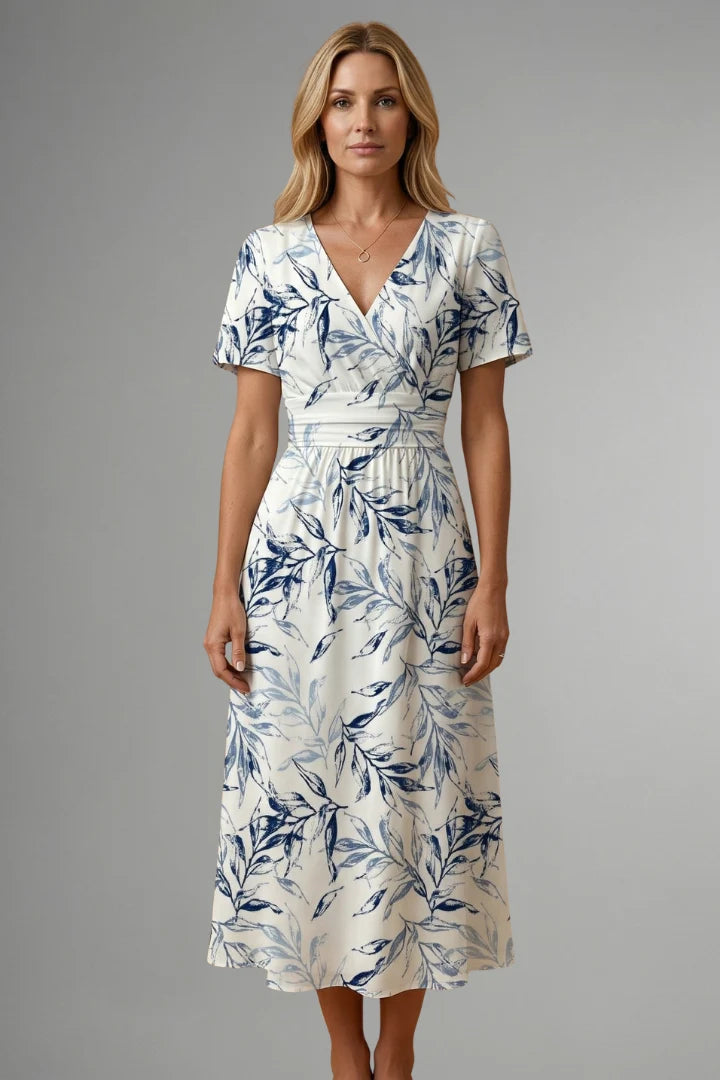 Front view of midi dress with V neckline and fitted waist showing blue floral print detail