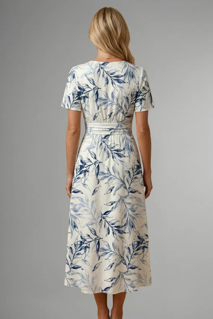 A-line midi dress with short sleeves and all-over blue botanical print on white fabric