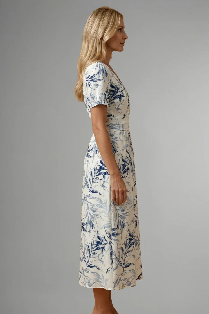 Flattering midi dress featuring V neckline, fitted waist, and flared A-line skirt with blue floral pattern