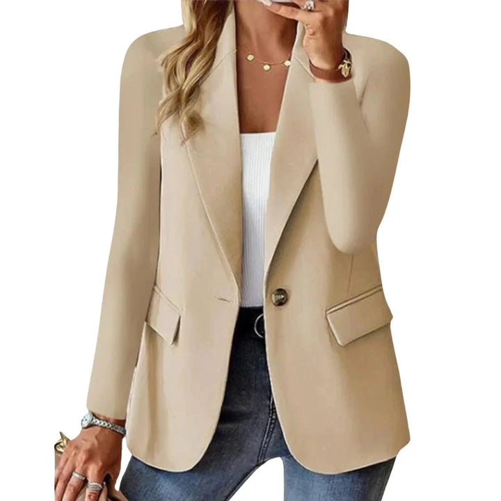 Women's single button blazer in beige with notched lapel and flap pockets styled over white ribbed top