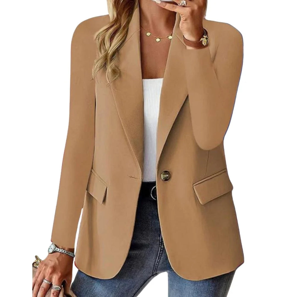 Close-up view of tailored women's blazer showing structured fabric and single button closure detail